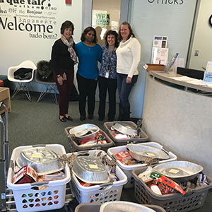 Employees standing near baskets of food